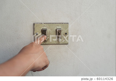 Hand turning the old electrical switches off. Hand turning the old electrical switches off. 60114326