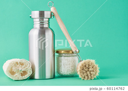 Set of eco friendly items on a green background. Set of eco friendly items on a green background. 60114762