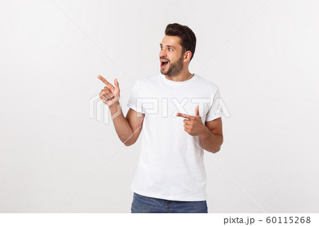 Amazed smart man pointing up at copy space over white background. 60115268