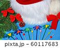 Santa Claus hat on a branch of spruce and toys. 60117683