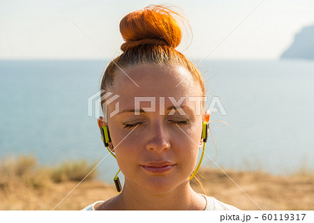 Fitness girl with wireless headphones 60119317