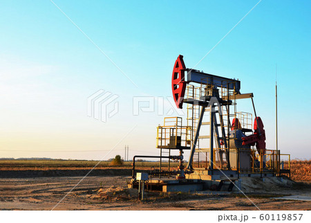 Oil drilling derricks at desert oilfield. Oil drilling derricks at desert oilfield. 60119857