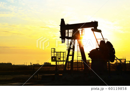 Oil drilling derricks at desert oilfield.  60119858