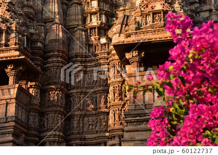 インドのカジュラーホー 世界遺産のカジュラーホー寺院 美しい彫刻と赤い花 インドのカジュラーホー 世界遺産のカジュラーホー寺院 美しい彫刻と赤い花 60122737