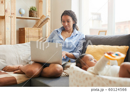 Young Mother Using Laptop Young Mother Using Laptop 60124566