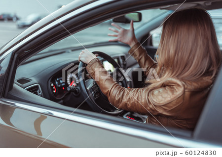 woman driving car jacket, shouting swearing negative accident stress on road, parking shopping center, fall city. Concept stress negative bad mood, emotions surprise, accident, conflict driving. woman driving car jacket, shouting swearing negative accident stress on road, parking shopping center, fall city. Concept stress negative bad mood, emotions surprise, accident, conflict driving. 60124830