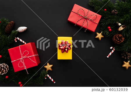 Christmas gift box and pine tree with xmas decoration on black background 60132039