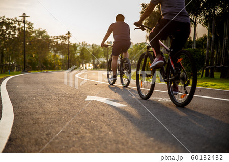 Two person ride on bike on the road. Two person ride on bike on the road. 60132432