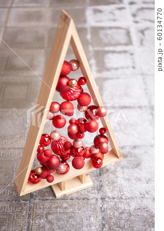 Alternative wooden christmas tree. A handmade Christmas tree and red christmas balls. 60134770