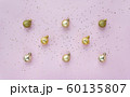 Creative pattern with golden balls and star confetti on pink pastel background top view. 60135807