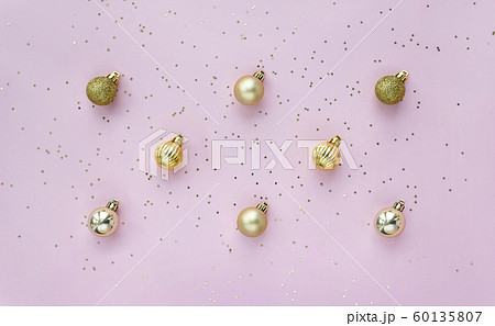 Creative pattern with golden balls and star confetti on pink pastel background top view. 60135807