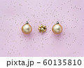 Golden christmas balls, golden bows and star confetti on pink pastel background top view. Flat lay 60135810