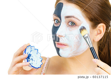 Girl black mask on half face apply white mud 60137115