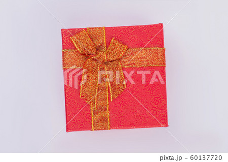 Red gift box with golden floral pattern and bow. Red gift box with golden floral pattern and bow. 60137720