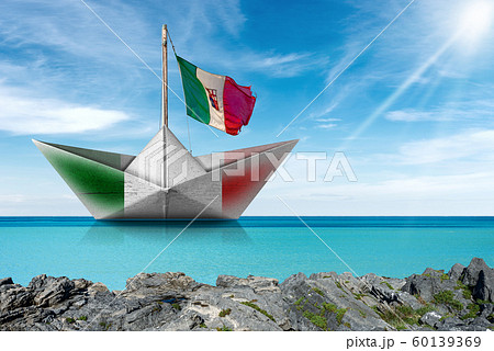 Paper boat with Italian flag in a turquoise sea - Photography 60139369