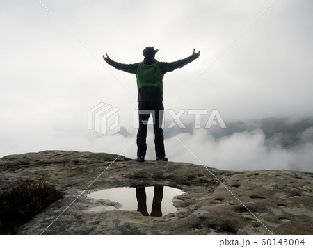 Ranger stay alone on edge mountain above heavy 60143004