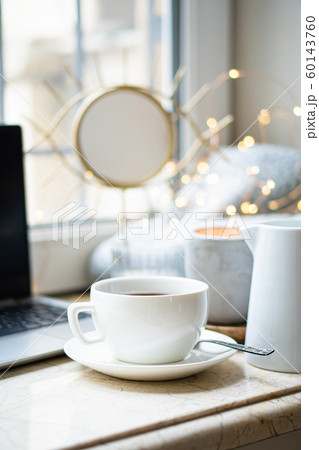 Cozy freelancer's winter work place at home with cup of coffee Cozy freelancer's winter work place at home with cup of coffee 60143760
