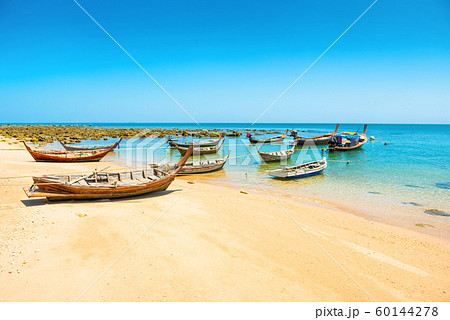 Traditional wooden boats moored at sand beach 60144278