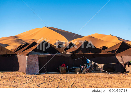 Luxury brown tent camp in Sahara Desert Merzouga, Morocco on a sunny day with sand dunes on background 60146713