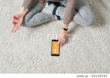 Crossed legs and hands of contemporary active girl doing yoga exercise Crossed legs and hands of contemporary active girl doing yoga exercise 60148583