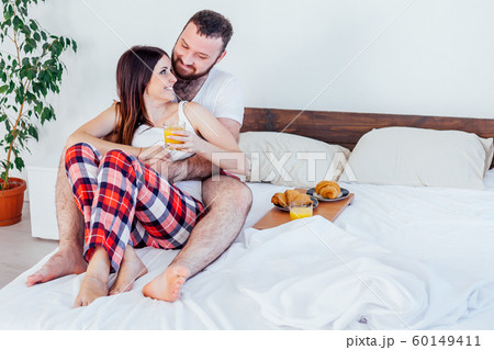 a man with a woman in the morning woke up to breakfast in bed 60149411