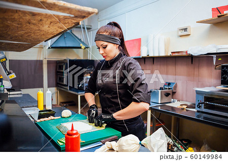 the Cook woman prepares food sushi restaurant kitchen 60149984