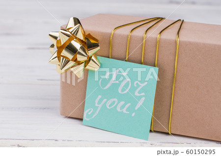 Gift box with bow and greeting card. 60150295