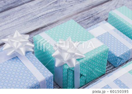 Gift boxes wrapped in elegant paper with bow. Gift boxes wrapped in elegant paper with bow. 60150395