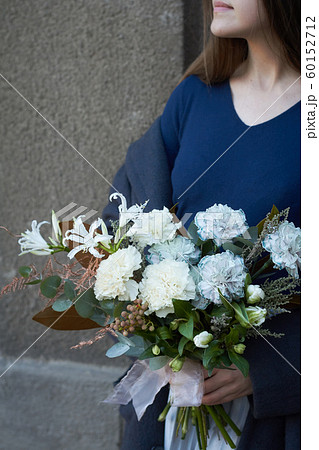 Girl holds white toned bouquet in vintage style 60152712