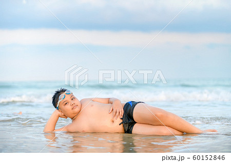 cute asian obese boy playing wave on beach, cute asian obese boy playing wave on beach, 60152846