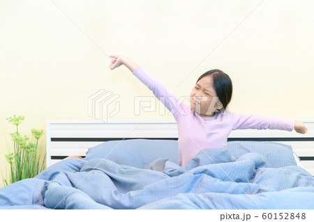 Cute girl stretching in bed after waking up, Cute girl stretching in bed after waking up, 60152848