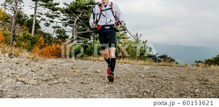 male runner with trekking poles male runner with trekking poles 60153621