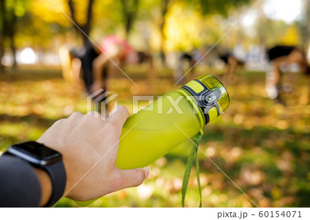 male hand holding bottle of water male hand holding bottle of water 60154071