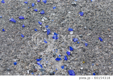 Blue broken glass on the asphalt Blue broken glass on the asphalt 60154318