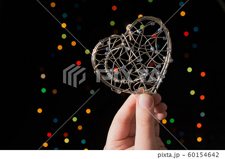 Heart shaped metal cage on bokeh light background Heart shaped metal cage on bokeh light background 60154642