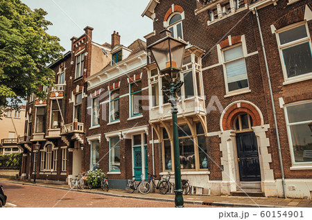 Elegant brick buildings and bicycles on a street of Dordrecht 60154901