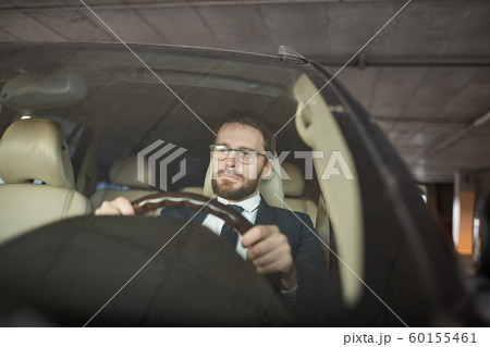 Serious man sitting in the car Serious man sitting in the car 60155461