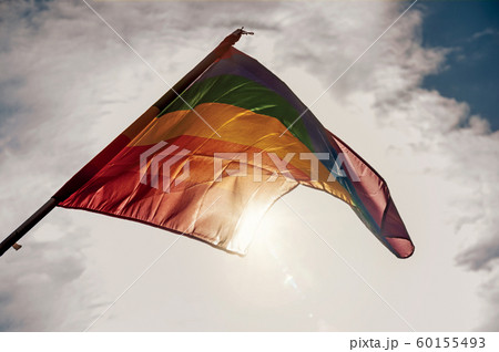 Rainbow flag fluttering against the sun 60155493