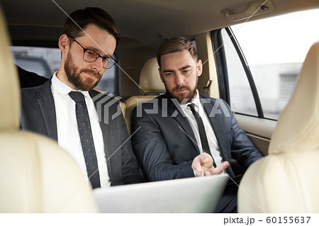 Business partners working in the car Business partners working in the car 60155637