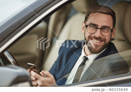 Successful businessman using mobile phone 60155639