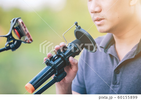 Close-up Singer holding a microphone stand and Close-up Singer holding a microphone stand and 60155899