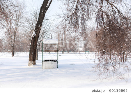 Well with water in a snowy field Well with water in a snowy field 60156665