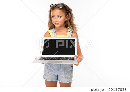 attractive european girl with glasses holding a computer in her hands with mockup on a light blue 60157033
