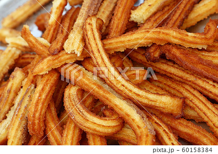 Close up sweet fresh churros snack on tray 60158384