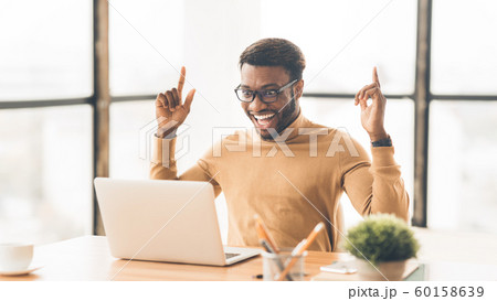 Happy african american guy celebrating his triumph 60158639