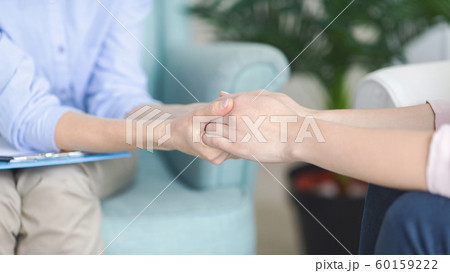 Psychotherapist consoling patient at her private clinic Psychotherapist consoling patient at her private clinic 60159222