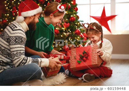 happy family mother, father and child with gifts happy family mother, father and child with gifts 60159448