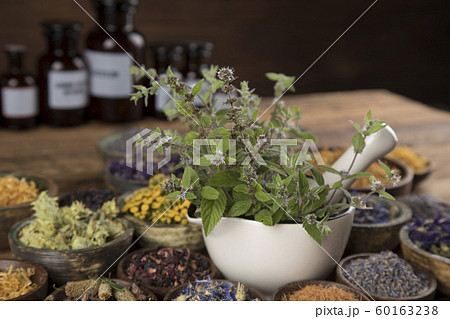 Natural remedy,Herbal medicine and wooden table Natural remedy,Herbal medicine and wooden table 60163238