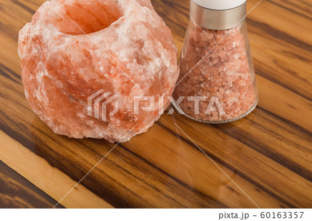 Natural salt and salt shaker on the varnished 60163357