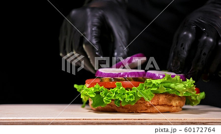 Craft burger is cooking. Consist: red sauce salsa, lettuce, red onion, pickle, cheese, chilli green pepper, air bun and marbled meat beef. Craft burger is cooking. Consist: red sauce salsa, lettuce, red onion, pickle, cheese, chilli green pepper, air bun and marbled meat beef. 60172764